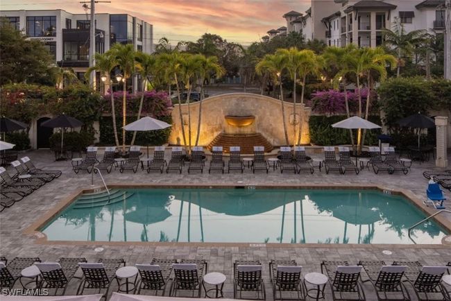 Community Pool at dusk featuring a patio area with plenty of lounge chairs | Image 31