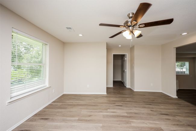 Spare room featuring ceiling fan, plenty of natural light, light wood-style flooring, and recessed lighting | Image 11