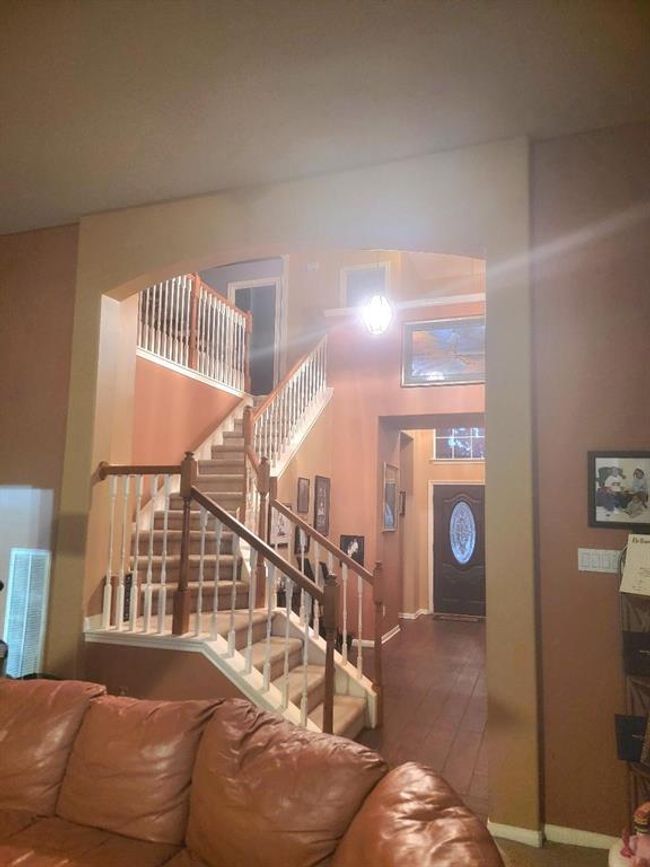Stairway up leads to the three bedrooms, gameroom, and full bathroom | Image 12