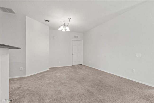 Unfurnished room with a chandelier and carpet floors | Image 14