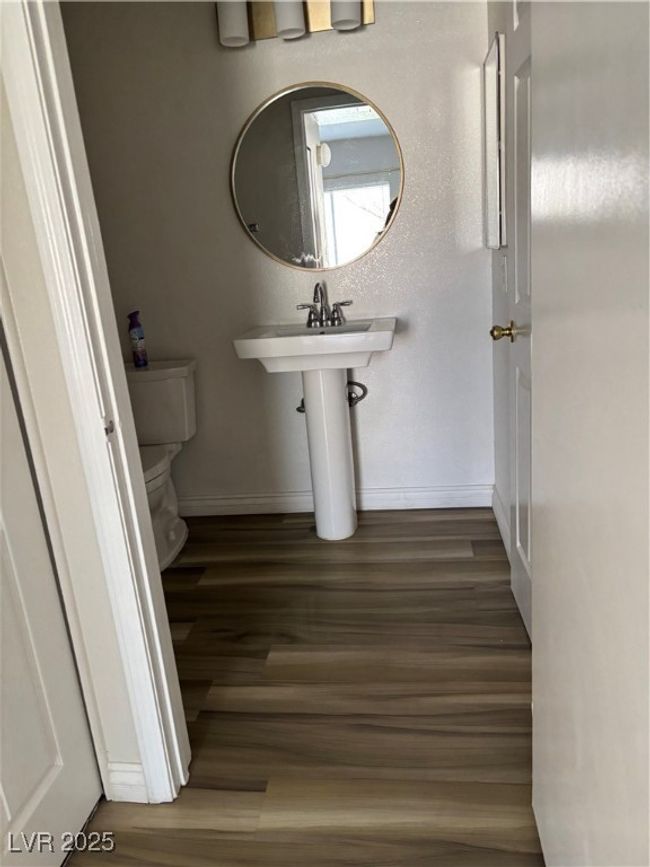 Bathroom with toilet, wood finished floors, and baseboards | Image 6