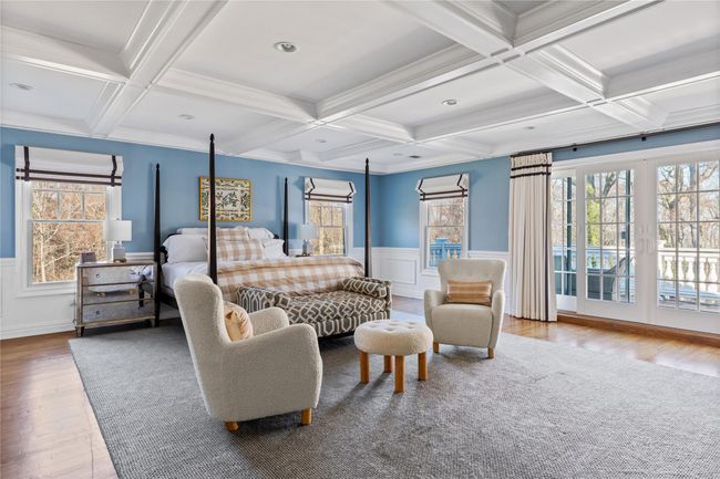 Bedroom with wood finished floors, beam ceiling, coffered ceiling, and multiple windows | Image 28