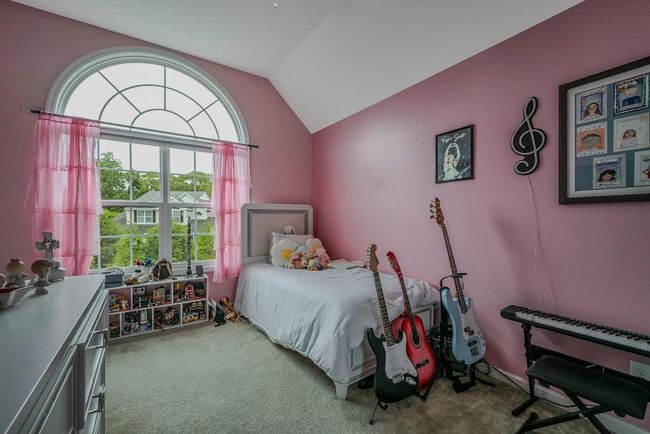 Bright Bedroom With Vaulted Ceiling & Carpeting | Image 18