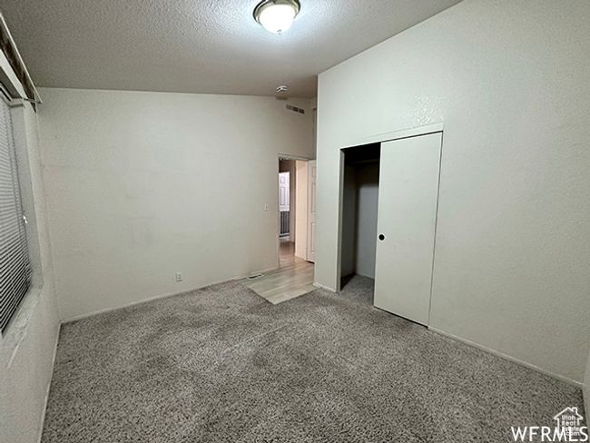 Unfurnished bedroom with carpet floors, a closet, visible vents, and a textured ceiling | Image 13