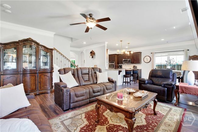 Family Room with views of the Breakfast Room, kitchen and ornate staircase | Image 21