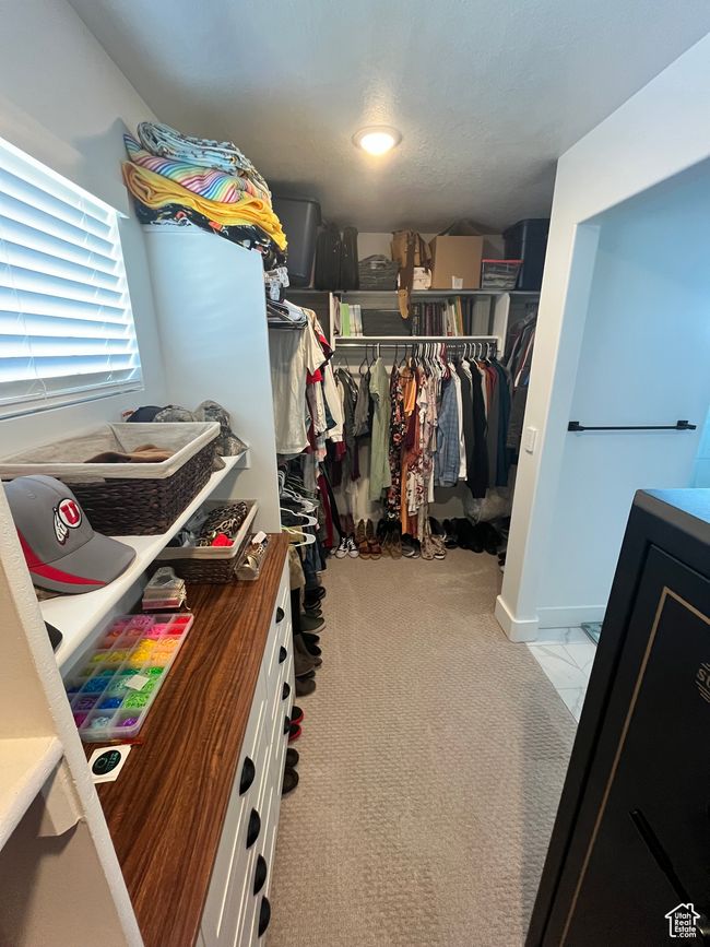 Spacious closet featuring light colored carpet | Image 18