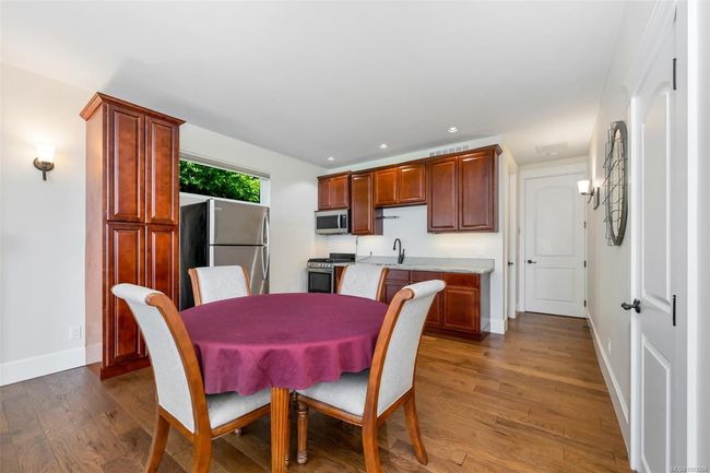 Dining room with recessed lighting, dark wood finished floors, and wet bar | Image 59