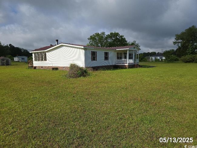 View of front of house with a front yard, crawl space, and covered porch | Image 9