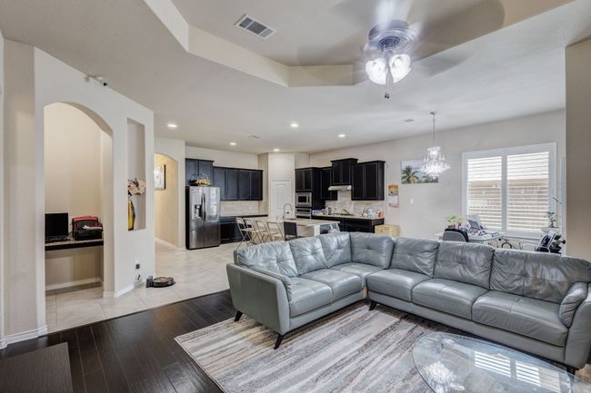 Living room with arched walkways, ceiling fan, light wood-type flooring, recessed lighting, and baseboards | Image 18