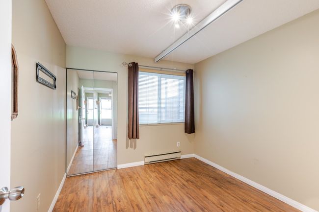 Bedroom featuring baseboards, light wood-style flooring, and a baseboard radiator | Image 31