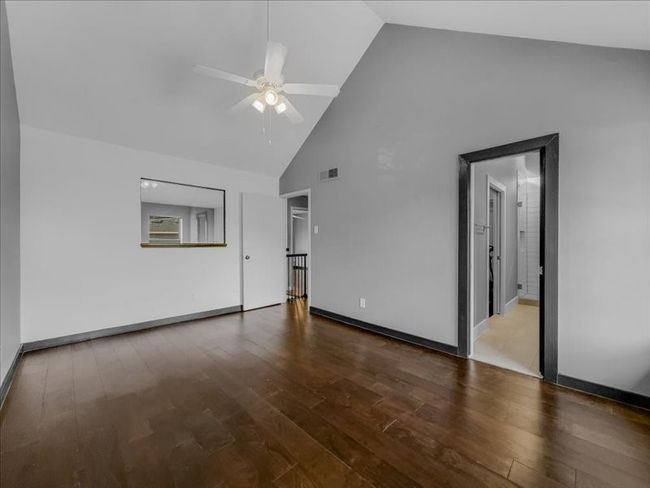 Upstairs bedroom featuring hardwood / wood-style floors, high vaulted ceiling, and ceiling fan | Image 16