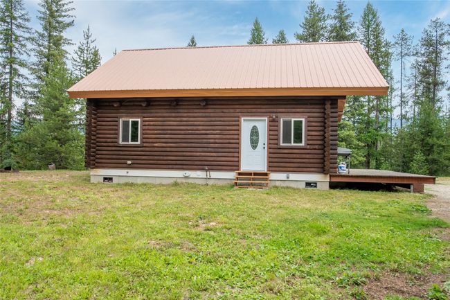 Log cabin with entry steps, log exterior, a front lawn, and a metal roof | Image 53
