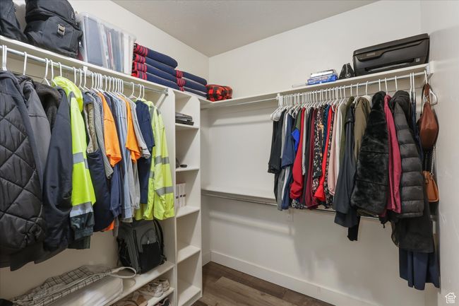 Walk in closet featuring wood finished floors | Image 12