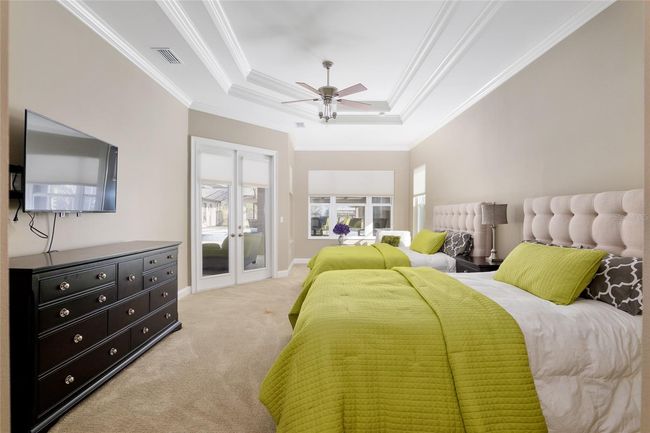 Master bedroom with access to pool and sitting area in background | Image 46