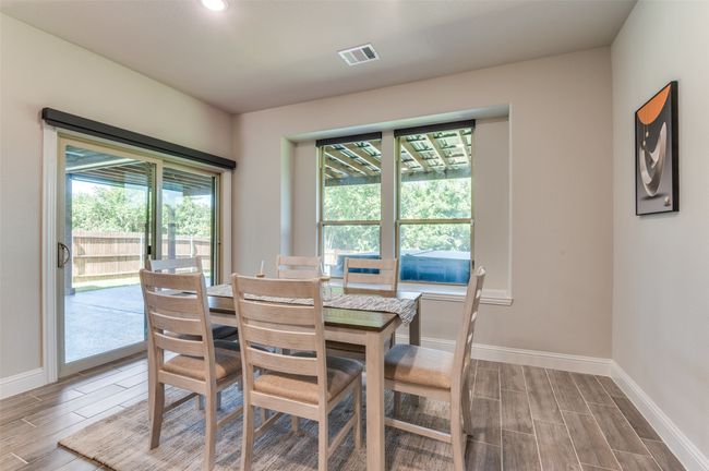 Dining area featuring wood finish floors and healthy amount of natural light | Image 9