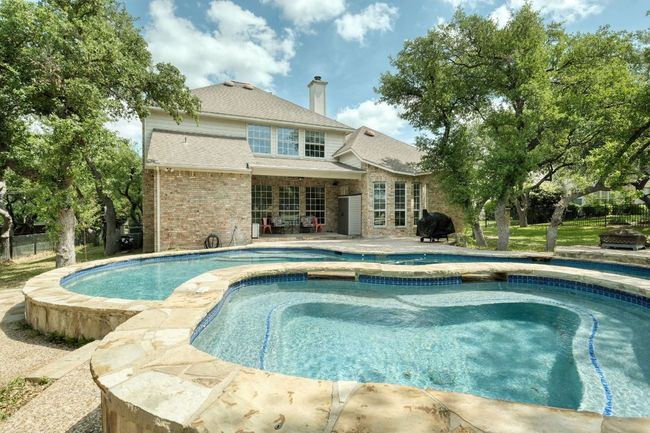 Outdoor pool with grilling area and a patio | Image 30