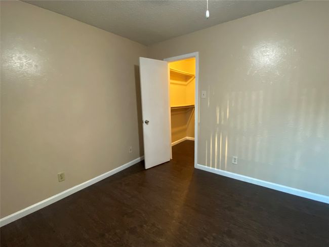 Empty room featuring dark wood-style flooring and baseboards | Image 11