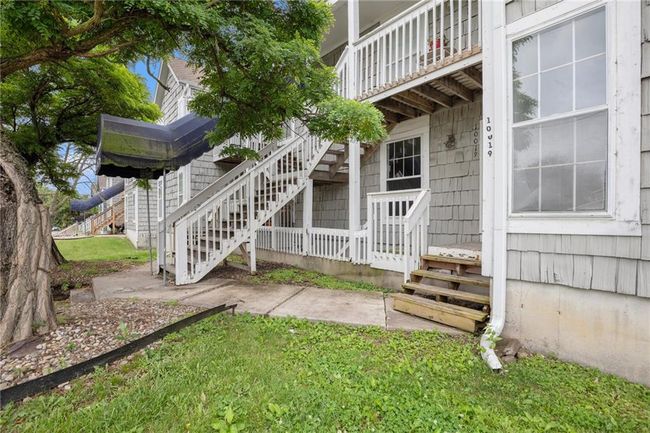 View of exterior entry featuring a balcony and a lawn | Image 16