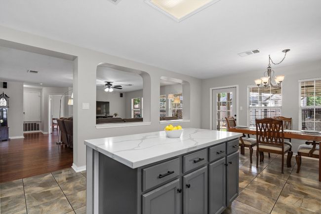 center island is great for entertaining overlooking the eating dining space and living area. | Image 13