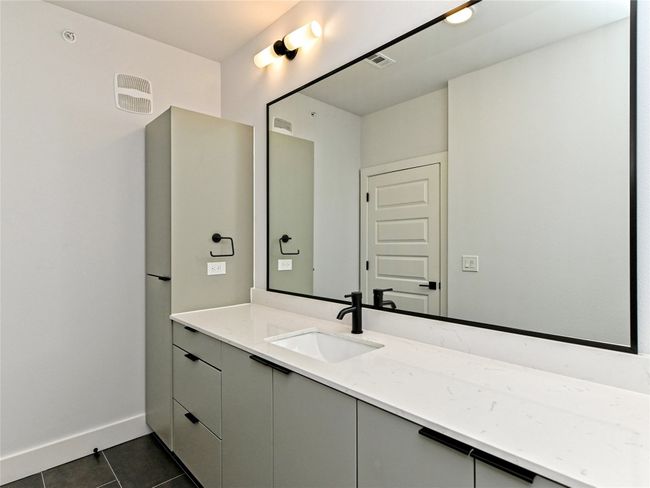 Bathroom featuring tile patterned floors, vanity, and baseboards | Image 12