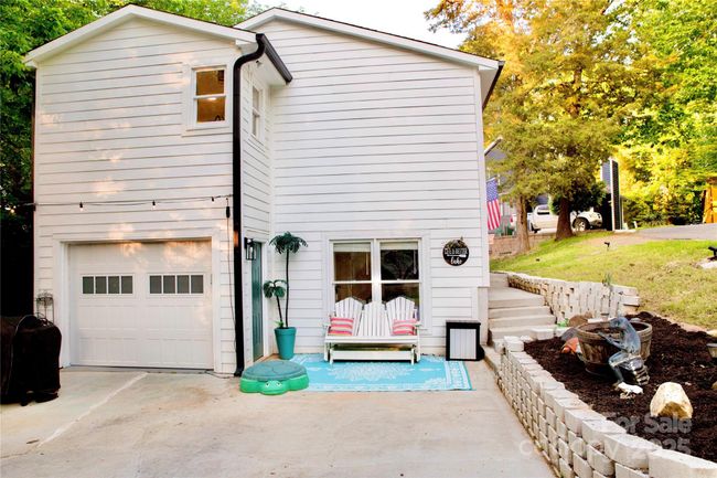 One car garage and wide driveway for parking. | Image 34