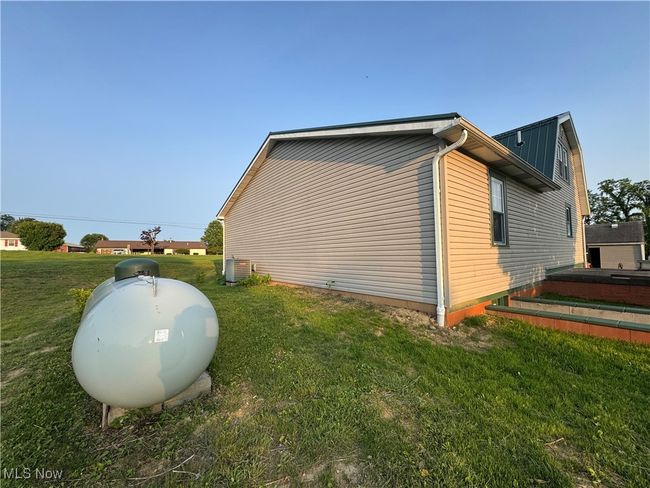 View of home's exterior with a yard and central AC unit | Image 38