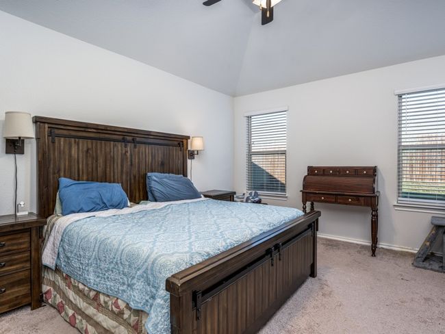 Bedroom with light carpet, multiple windows, lofted ceiling, and a ceiling fan | Image 17