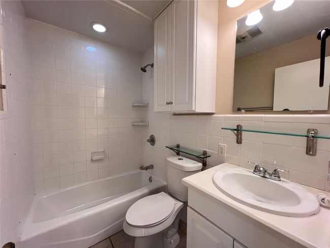 Bathroom with vanity, tub / shower combination, tasteful backsplash, tile walls, and recessed lighting | Image 6