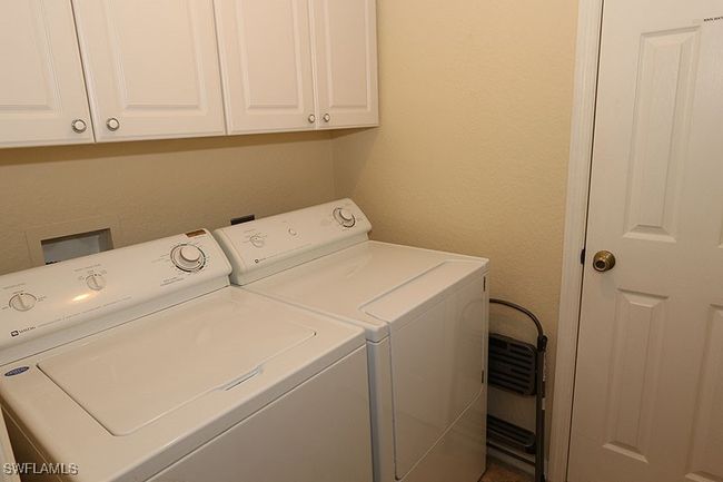 Laundry area with washer and clothes dryer, cabinets, and washer hookup | Image 19