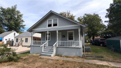 Bungalow featuring covered porch and central AC | Image 1