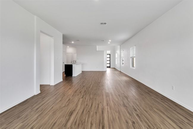 Unfurnished living room featuring dark wood-style flooring and recessed lighting | Image 9