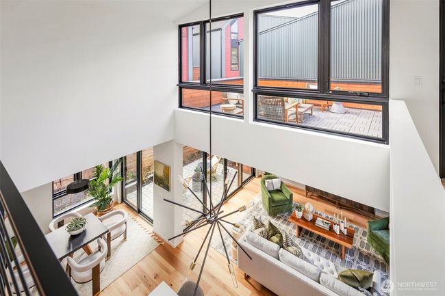 The large windows throughout the home flood the space with natural light, complementing the hickory wide plank hardwood floors that extend throughout, creating a warm and inviting atmosphere. | Image 15