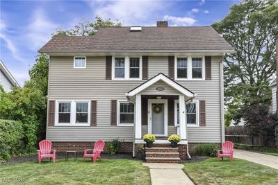 Colonial inspired home featuring a front yard | Image 1