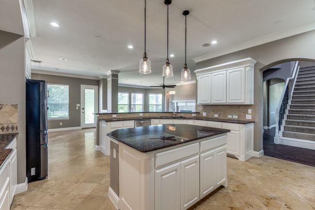 Kitchen with a island, crown molding, stainless steel dishwasher, and arched walkways | Image 15