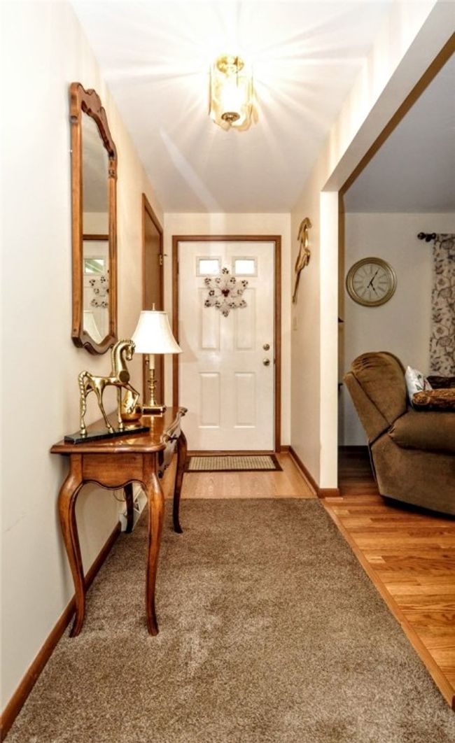 The spacious entryway with the livingroom off to the right | Image 14