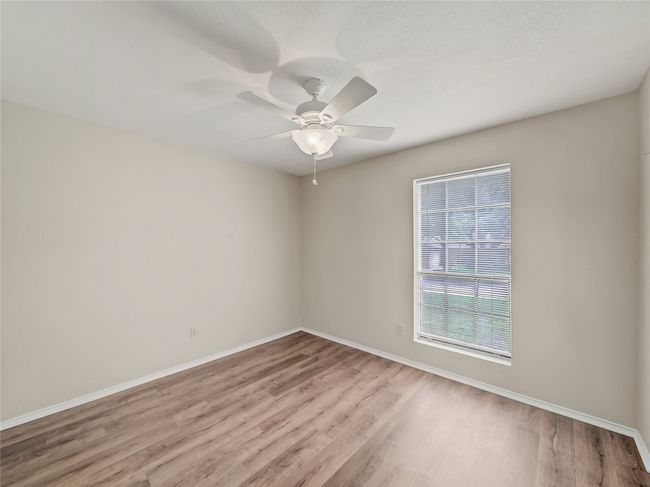 Spare room with wood finished floors, baseboards, and ceiling fan | Image 19