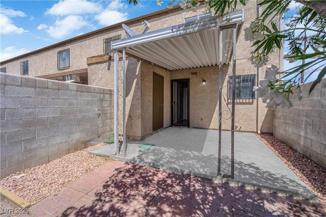 View of exterior entry featuring stucco siding, a patio, and fence | Image 19