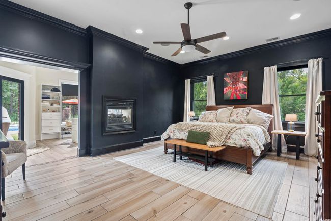 Bedroom featuring crown molding, light wood-style floors, recessed lighting, and multiple windows | Image 16