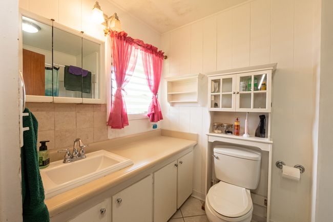 Bathroom (with bathtub) with separate bedroom entrance @ 007 Kaapuni Loop in Hilo. | Image 8