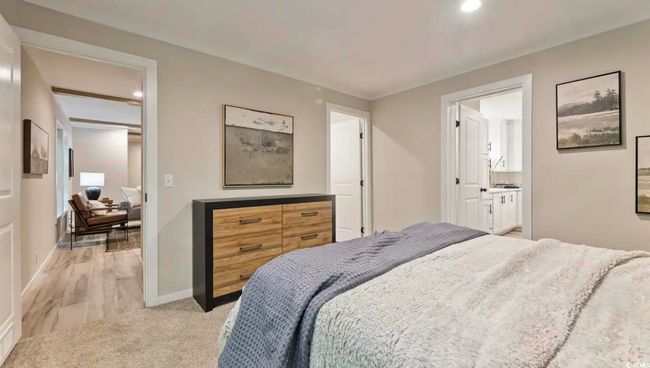 Bedroom featuring baseboards, recessed lighting, light carpet, and ensuite bathroom | Image 22