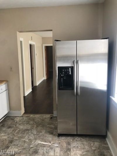 Kitchen featuring stainless steel refrigerator with ice dispenser | Image 2