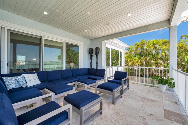 Huge covered 2nd story balcony with travertine tile. | Image 17