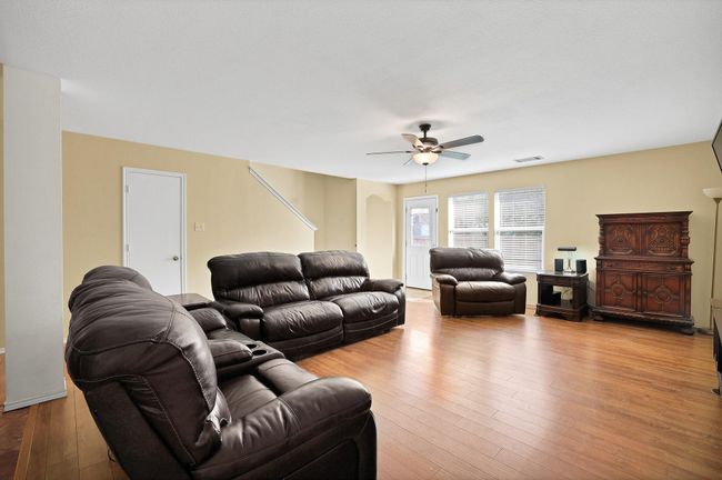 Living room featuring a ceiling fan and hardwood / wood-style flooring | Image 6