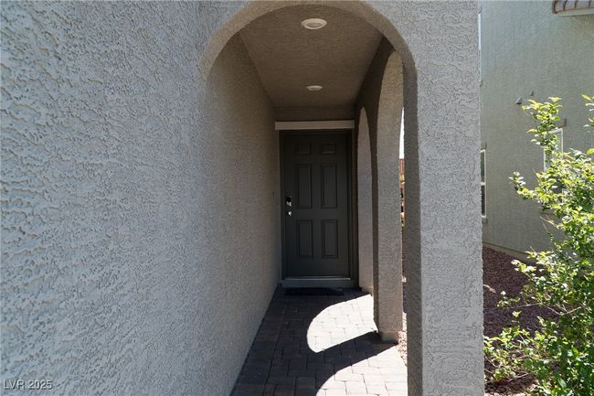 View of exterior entry with stucco siding | Image 5