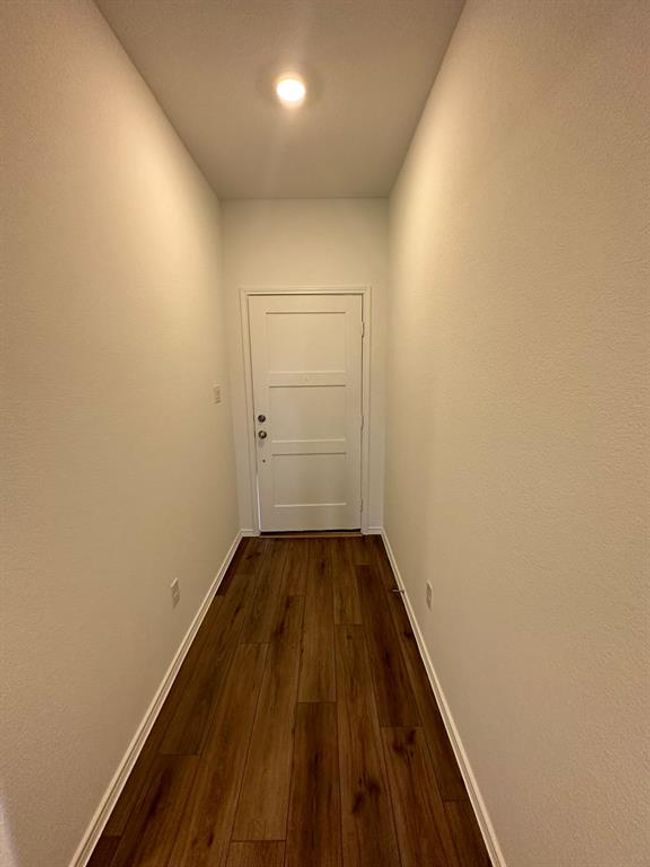 Corridor featuring dark wood-style flooring and baseboards | Image 4