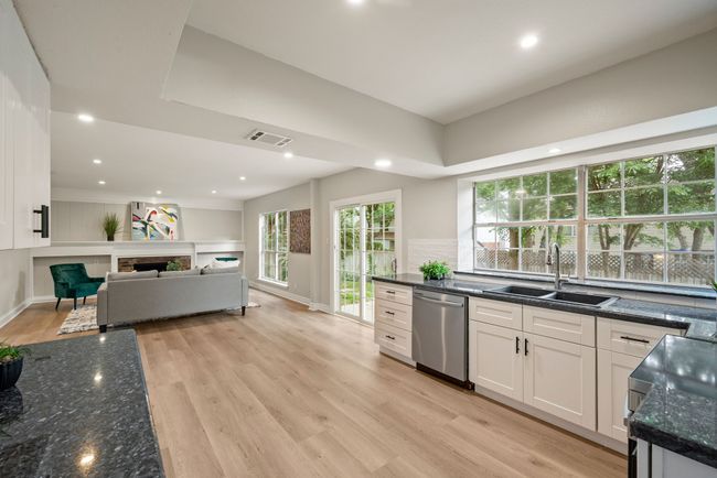 The living room flows seamlessly into the kitchen and dining areas for an open-concept feel. | Image 10