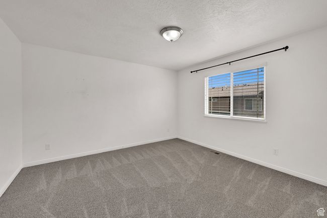 Carpeted empty room with baseboards and a textured ceiling | Image 24