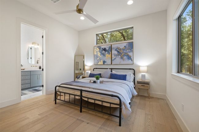 Bedroom featuring ensuite bath, light wood-style flooring, baseboards, and recessed lighting | Image 14
