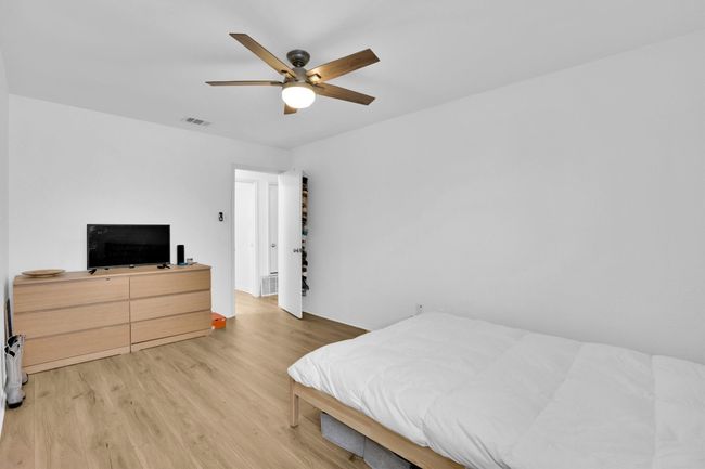 Bedroom with light wood-style floors and a ceiling fan | Image 22