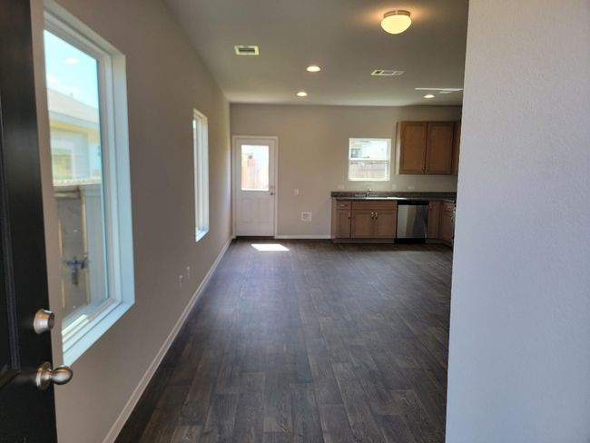 Kitchen with dishwasher, dark countertops, dark wood-style floors, and recessed lighting | Image 6